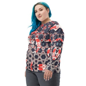May include: A long-sleeved sweatshirt featuring a koi fish pattern. The design incorporates red, white, and black koi fish against a geometric background of gray, navy, and red shapes. The sweatshirt has a crew neck and a relaxed fit.