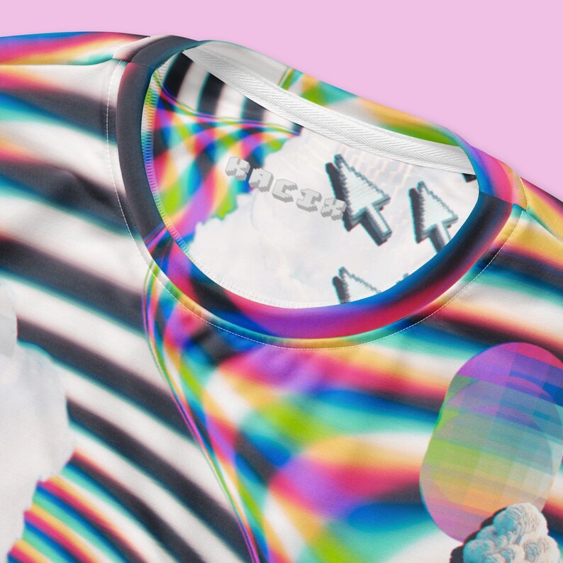May include: A colorful t-shirt with a striped pattern and a pixelated design. The shirt has a crew neck and is made of a soft, comfortable fabric. The design features a rainbow gradient with a pixelated effect, and the text "HACK1X" is visible on the shirt.