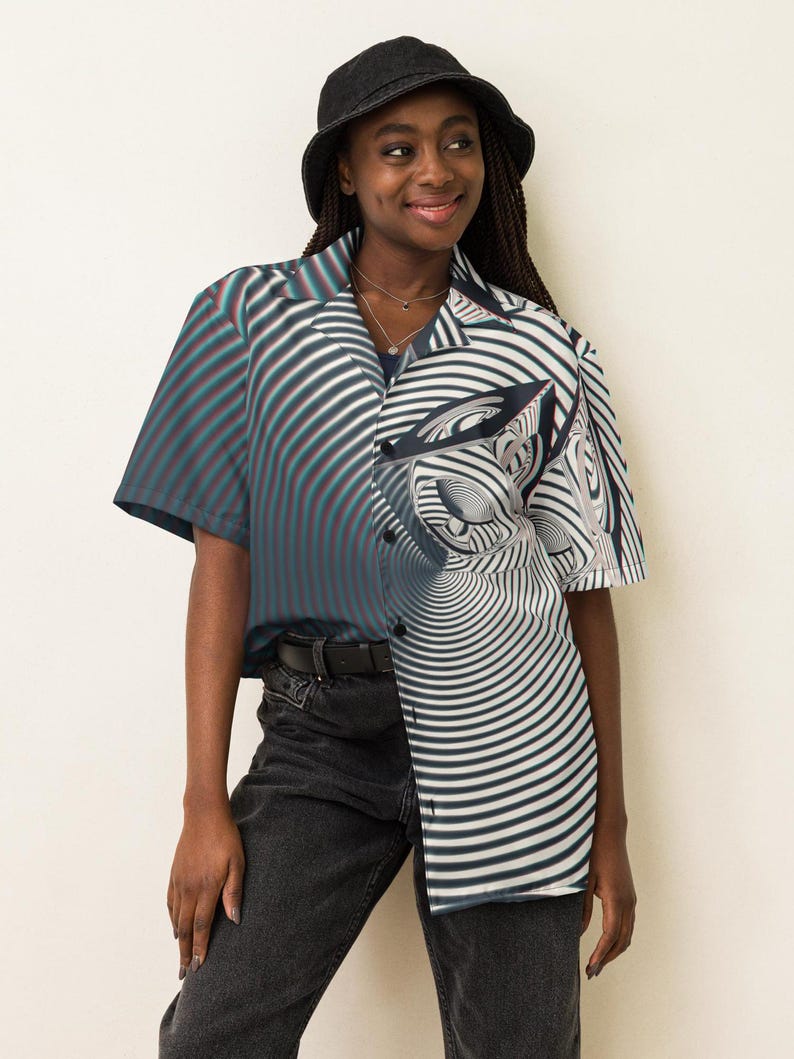 May include: A person wearing a black and white striped button-up shirt with a swirling pattern. The shirt has short sleeves and a collar. The person is also wearing a black bucket hat and black jeans.