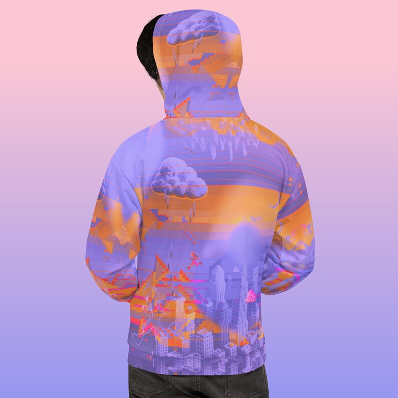 May include: A hooded sweatshirt with a vibrant, abstract design. The artwork features a cityscape with stylized buildings, clouds, and a sunset color palette of purple, orange, and pink. The hoodie is viewed from the back.