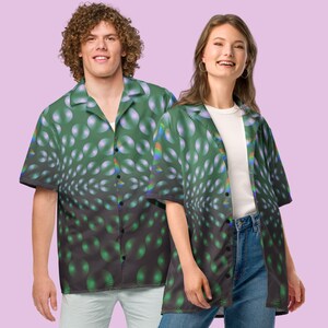 May include: Two people wearing short-sleeved button-down shirts with a green and black geometric pattern. The pattern features a repeating design of circles with a gradient of colors, including green, white, and black.