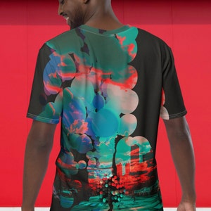 May include: A black t-shirt with a colorful graphic print of a city scene with a person walking across a crosswalk. The graphic features a pattern of overlapping circles in shades of blue, green, and red.