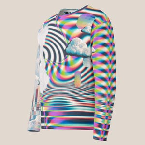 May include: A long-sleeved shirt with a psychedelic print featuring a rainbow, clouds, and a swirling pattern. The shirt is white with a variety of colors, including pink, blue, green, and yellow.