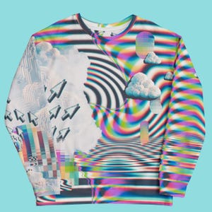 May include: A white long-sleeved sweatshirt with a colorful, psychedelic print featuring clouds, arrows, and a swirling, rainbow-like pattern.