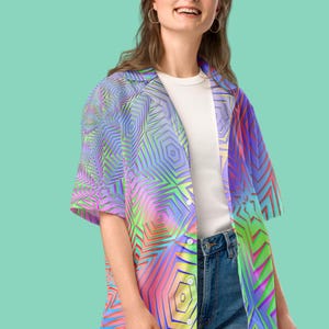 May include: A colorful button-down shirt with a geometric pattern in shades of pink, blue, green, and yellow. The shirt has a relaxed fit and short sleeves.