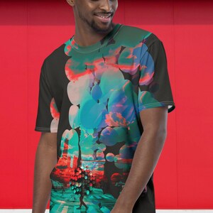 May include: A black t-shirt with a colorful abstract design featuring a cityscape with a person walking across a crosswalk. The design includes circles, clouds, and a sunset.