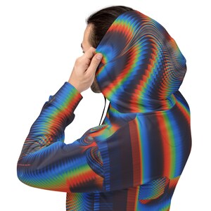 May include: A hooded sweatshirt with a colourful, abstract pattern in shades of blue, red, orange, and yellow. The pattern resembles a swirling, pixelated design.
