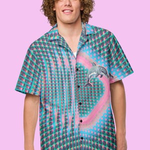 May include: A blue, green, and pink short-sleeved button-down shirt with a geometric pattern and a dolphin graphic.