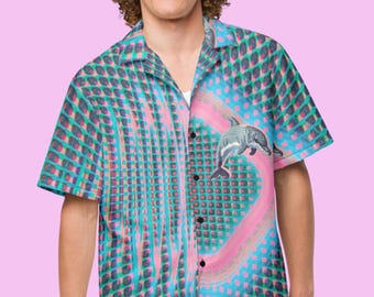 May include: A blue, green, and pink short-sleeved button-down shirt with a geometric pattern and a dolphin graphic.