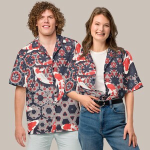 May include: Short-sleeved shirt with a koi carp and geometric pattern in red, white, and navy blue. The shirt has a relaxed fit, suitable for casual wear. The design features a repeating pattern of koi carp and floral elements.