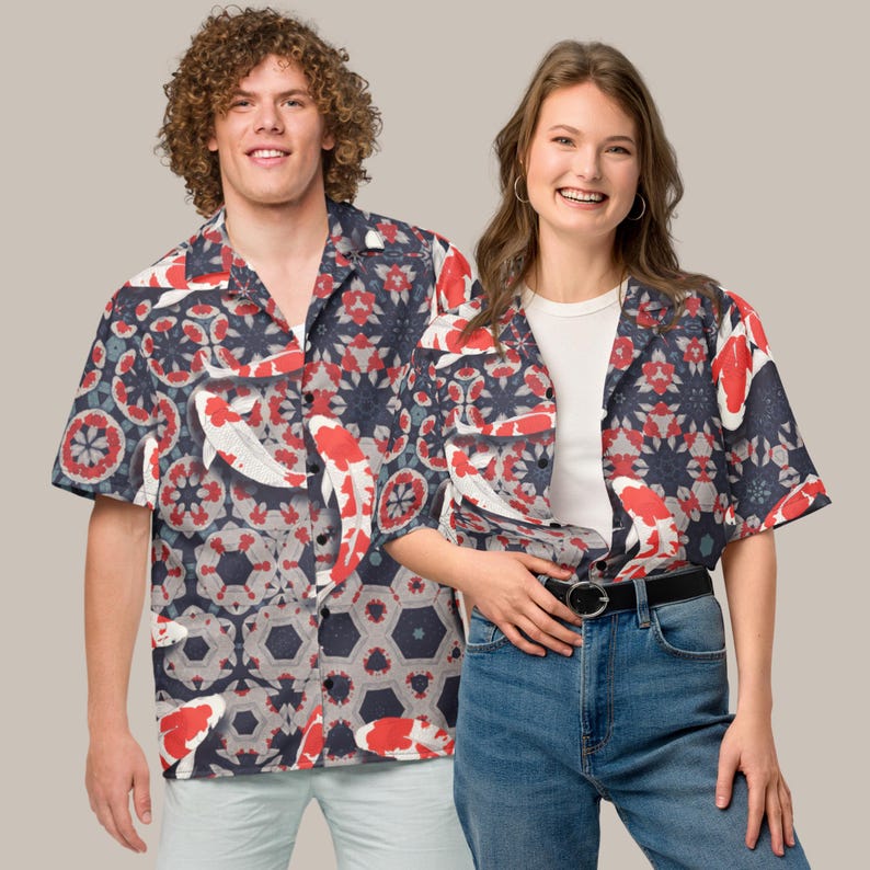 May include: Short-sleeved shirt with a koi carp and geometric pattern in red, white, and navy blue. The shirt has a relaxed fit, suitable for casual wear. The design features a repeating pattern of koi carp and floral elements.