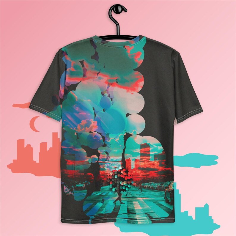 May include: A black t-shirt with a colorful abstract design featuring a cityscape and a person walking on a crosswalk. The design is made up of circles and swirls in shades of blue, pink, and red.