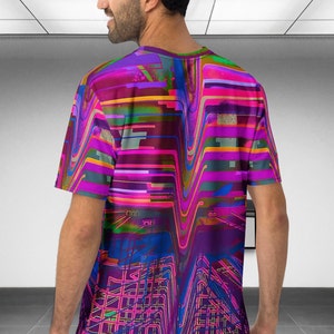 May include: A short-sleeved t-shirt with a colorful abstract design featuring wavy lines and geometric shapes in shades of pink, purple, blue, green, and yellow.