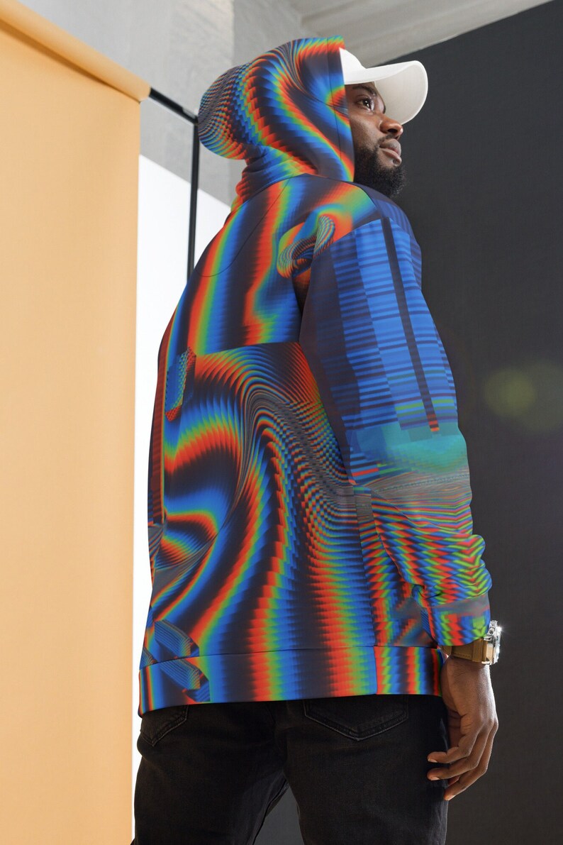 May include: A black hoodie with a colourful, abstract, pixelated design. The hoodie has a hood and a zip closure.