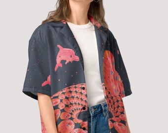 May include: A button-down shirt with a unique, colorful design. The shirt features a dark blue background with pixelated pink dolphins and a vibrant, abstract pattern in shades of red, orange, and yellow. The shirt is paired with blue jeans.