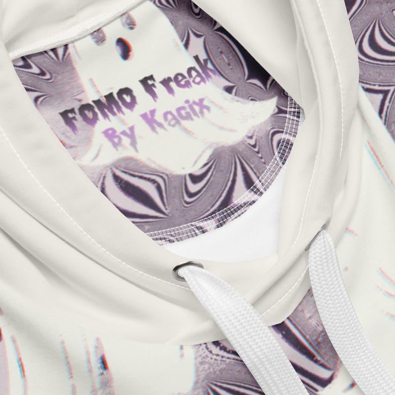 Puede incluir: Sudadera con capucha blanca con un gr&aacute;fico de fantasma y el texto "FOMO Freak by Kagix".