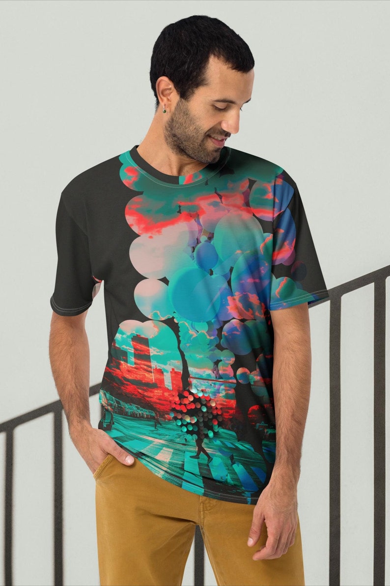 May include: A black t-shirt with a colorful abstract design featuring circles and a cityscape. The design includes shades of blue, green, pink, and red.
