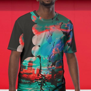 May include: A black t-shirt with a colorful abstract design featuring circles, clouds, and a cityscape. The design is on the right side of the shirt.