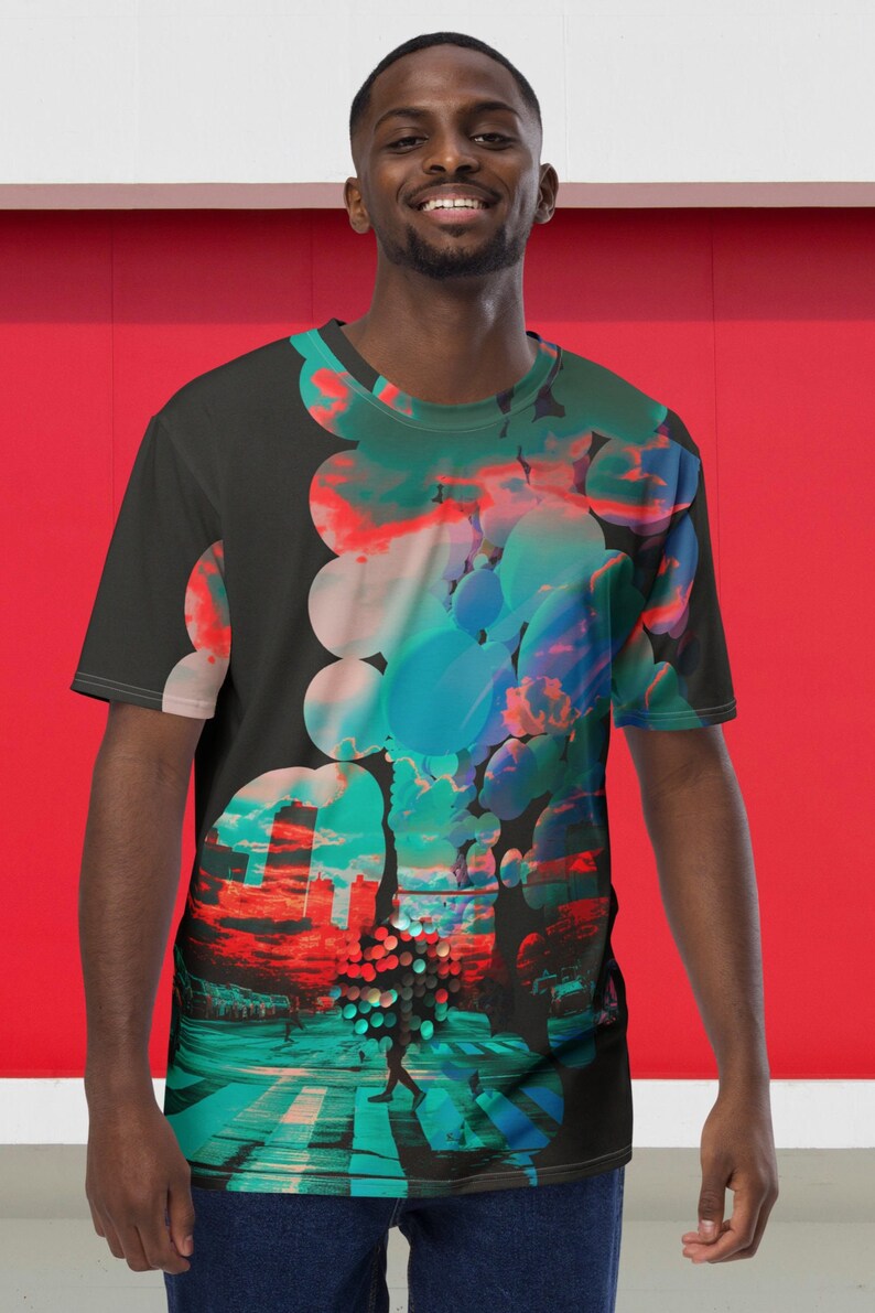 May include: A black t-shirt with a colorful abstract design featuring circles, clouds, and a cityscape. The design is on the right side of the shirt.