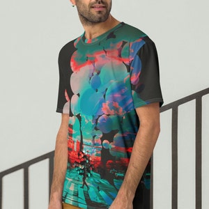 May include: A black t-shirt with a colorful abstract design featuring circles, clouds, and a cityscape. The design is in shades of blue, red, pink, and green.