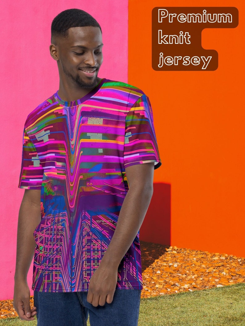 May include: A man is wearing a purple, pink, and blue t-shirt with a geometric pattern. The t-shirt has a crew neck and short sleeves. The text "Premium knit jersey" is in the upper right corner of the image.