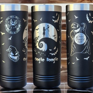 May include: Three black stainless steel tumblers with different Nightmare Before Christmas designs. The first tumbler features the text "Well, well, well, what have we here?" and a character with a stitched face. The second tumbler features the text "Oogie Boogie" and a character with a stitched face. The third tumbler features a scene from the movie with Jack Skellington and Sally.