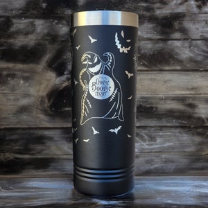 May include: Black stainless steel tumbler with a white engraved design of a character from the movie "The Nightmare Before Christmas". The design includes the character's name, "Oogie Boogie", and bats flying around the character.