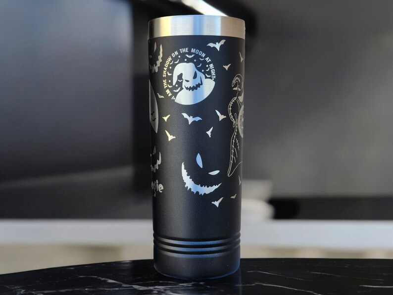 May include: Black stainless steel tumbler with a white design featuring bats, a moon, and the text "The Shadow on the Moon at Night".