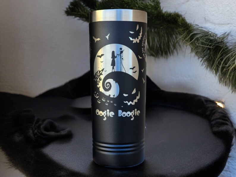 May include: Black stainless steel tumbler with a white silhouette of Jack Skellington and Sally from The Nightmare Before Christmas on a black background. The text "Oogie Boogie" is at the bottom of the tumbler.