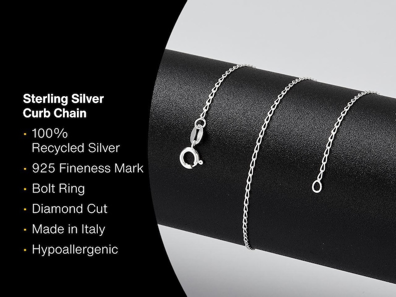 May include: A sterling silver curb chain with a bolt ring clasp, displayed on a black surface. The chain is diamond cut and made in Italy. Text on the left indicates it is 100% recycled silver and hypoallergenic.