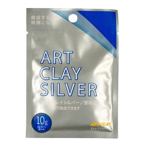 May include: A silver-colored rectangular foil pouch labeled ART CLAY SILVER in blue text. The packaging features a blue diagonal stripe at the top, a circular 10g weight indicator, and Japanese text. The bottom right corner displays the text ART CLAY Eco Friendly.