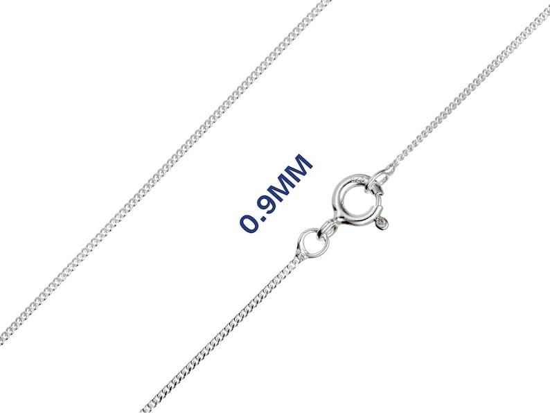 May include: A silver curb chain necklace with a spring ring clasp. The chain is 0.9mm thick. The necklace is shown against a white background.