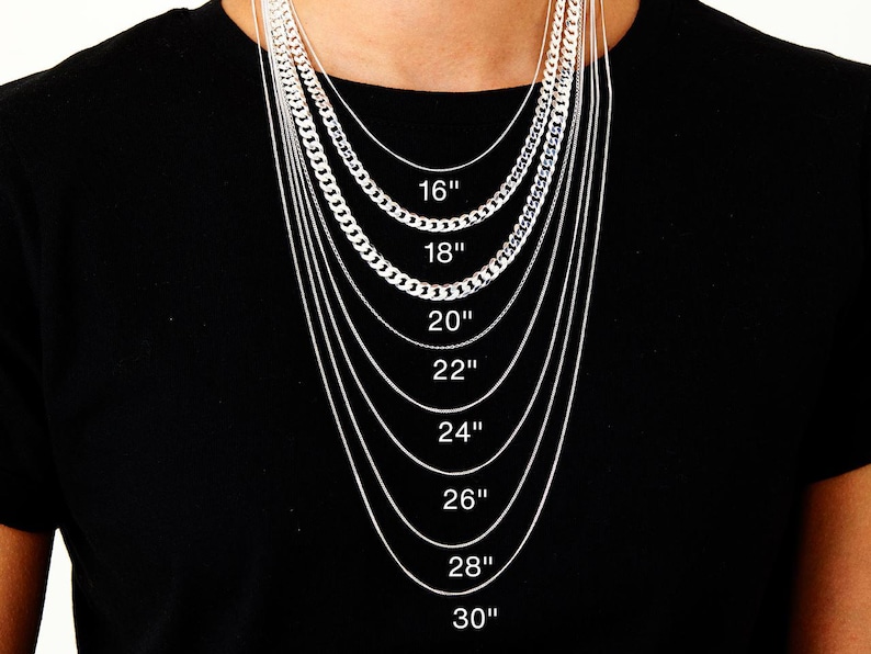May include: A person wearing a black top, showcasing various silver necklaces of different designs and lengths. The necklaces are labelled with lengths from 16 inches to 30 inches (40.6 cm to 76.2 cm).