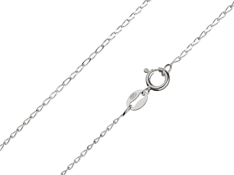 May include: A delicate silver chain necklace with a spring ring clasp. The chain is made of small, interconnected links. The clasp has a small tag with the number "925" stamped on it, indicating the metal's purity.