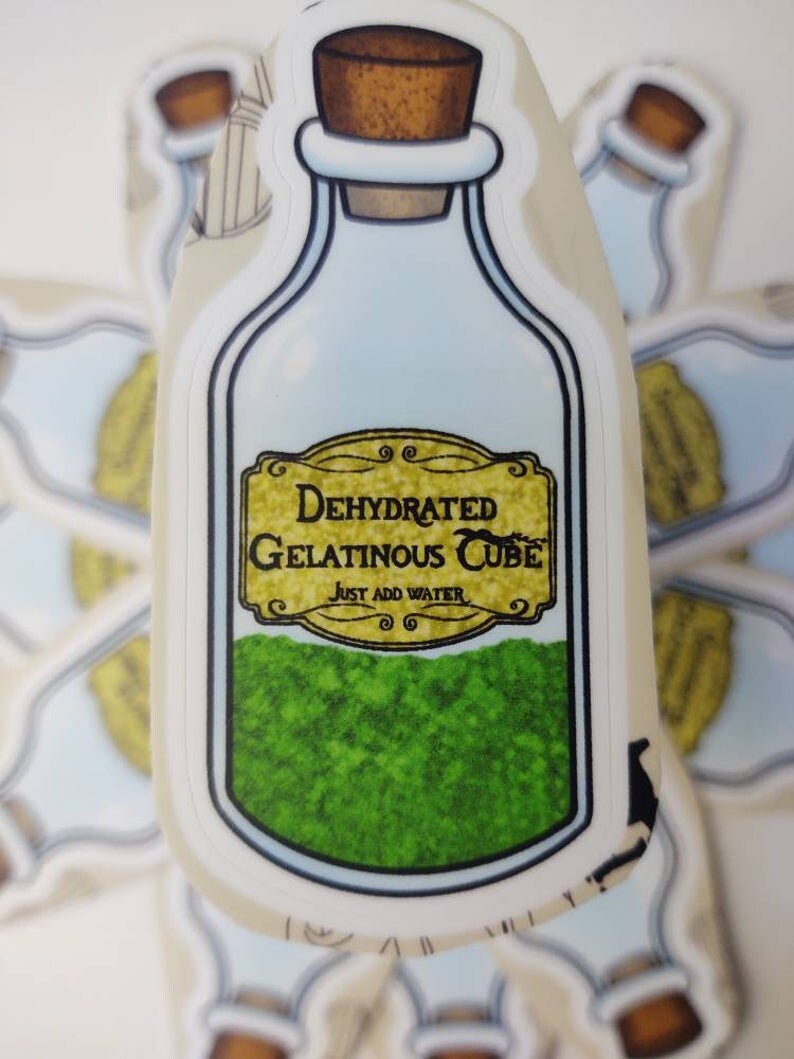 May include: A sticker of a glass bottle with a cork stopper. The bottle is filled with a green powder and has a label that reads "Dehydrated Gelatinous Cube" and "Just Add Water".
