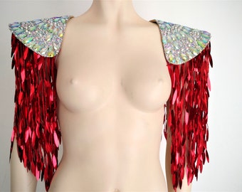 May include: A pair of shoulder epaulets featuring iridescent, multi-faceted crystals on the top panels. Long, metallic red, leaf-shaped sequin fringe hangs from the base of each shoulder piece, creating a cascading effect over the upper arms.