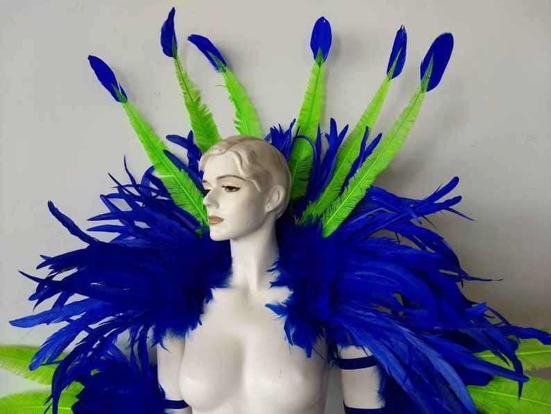 May include: A blue and green feather costume with a large blue feather boa and several green feathers with blue tips.