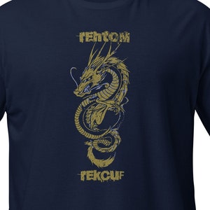 May include: A navy blue t-shirt with a gold dragon graphic and the text "FEKCUF" and "IENTCM" printed on the front.