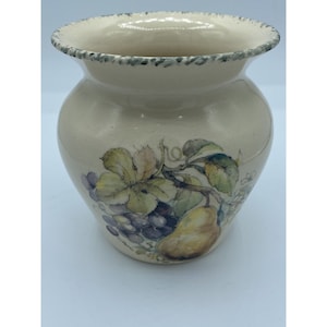 May include: A cream-colored ceramic vase with a green rim and a painted design of a pear, grapes, and leaves.