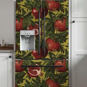 May include: A French door refrigerator featuring a vibrant botanical pattern of red pomegranates and dark green leaves set against a mustard yellow background. The appliance includes a built-in water and ice dispenser on the left door.