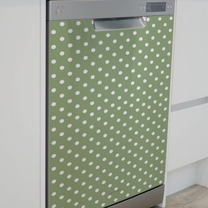 May include: A stainless steel dishwasher with a green and white polka dot design. The dishwasher is in a kitchen setting.