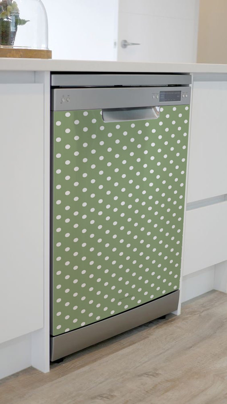 May include: A stainless steel dishwasher with a green and white polka dot design. The dishwasher is in a kitchen setting.