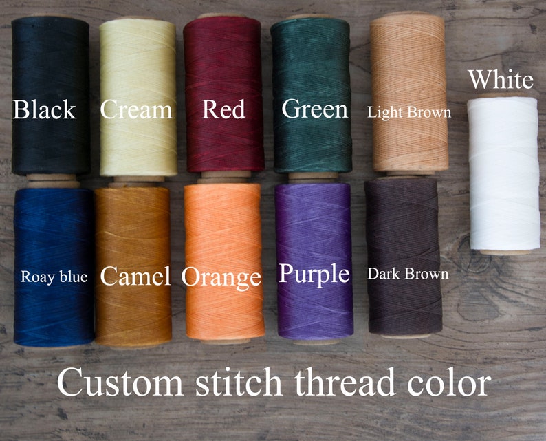 May include: A selection of colorful spools of thread in various shades, including black, cream, red, green, light brown, white, roay blue, camel orange, purple, and dark brown. The text "Custom stitch thread color" is displayed below the spools.