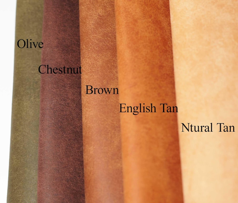 May include: A close-up of five leather swatches in varying shades of brown and tan. The colors are labeled Olive, Chestnut, Brown, English Tan, and Ntural Tan. The leather has a textured appearance.