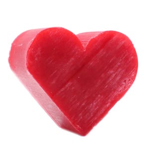 May include: A solid, bright red heart-shaped object with a smooth, slightly textured surface. The form is thick and dimensional, featuring a distinct cleft at the top and a pointed base, showcasing a uniform, vibrant red color throughout the entire piece.