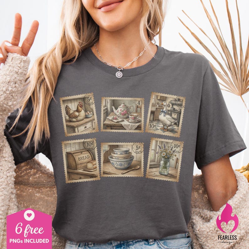 May include: Dark gray t-shirt featuring six vintage-style postage stamp designs with kitchen and farm scenes. The stamps depict a hen, teapot, goose, bread, bowls, and flowers. The shirt also has the text "6 free PNGs included".