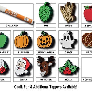 May include: A collection of decorative toppers, including a chalk pen, hop, wheat, red apple, green apple, pumpkin, Jack O' Lantern, ghost, pretzel, skull, Santa, reindeer, and holly. The text "Chalk Pen & Additional Toppers Available!" is also present.