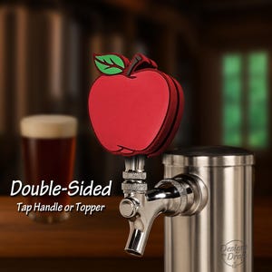 May include: A double-sided tap handle or topper with a red apple design. The apple has a green leaf and black trim. The tap handle is made of stainless steel and is attached to a beer tap.