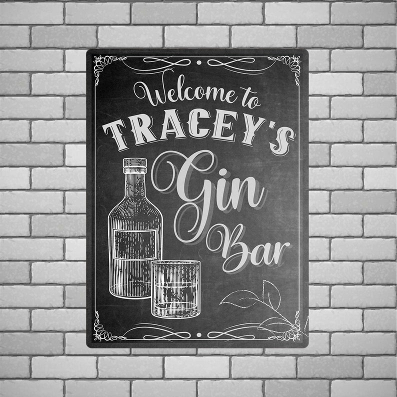 May include: Black and white chalkboard sign with the text "Welcome to Tracey's Gin Bar" and illustrations of a bottle of gin and a glass.