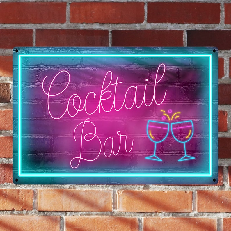 May include: Neon sign with a blue border and a pink background. The sign says "Cocktail Bar" in white cursive lettering with two neon pink glasses clinking together.